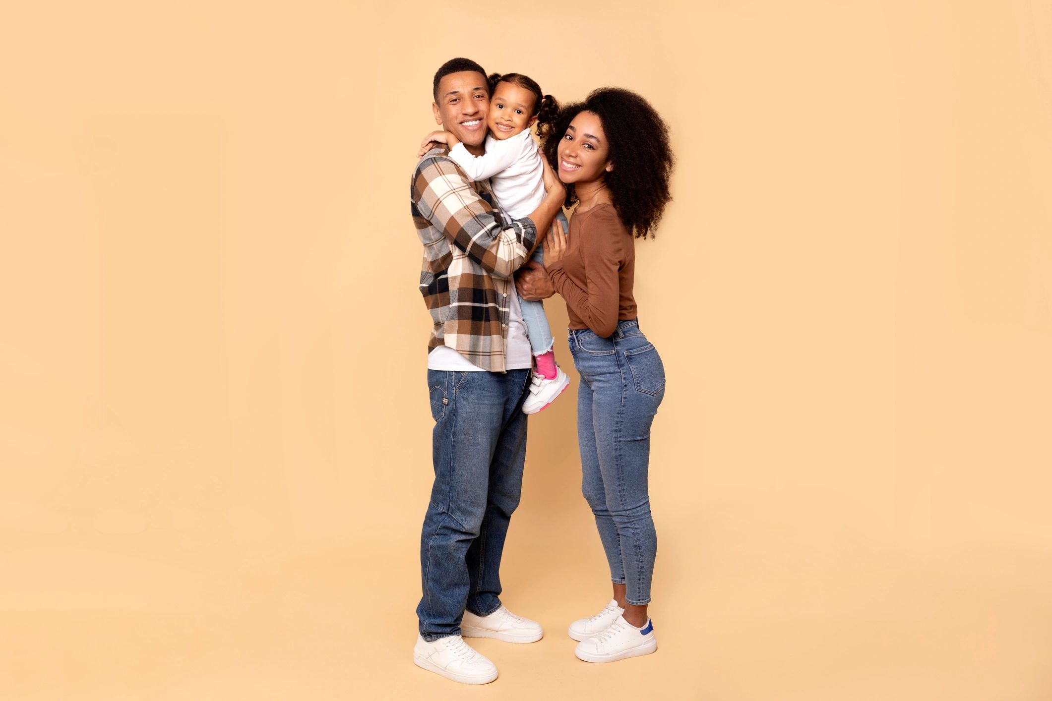 Happy family posing together in coordinated outfits